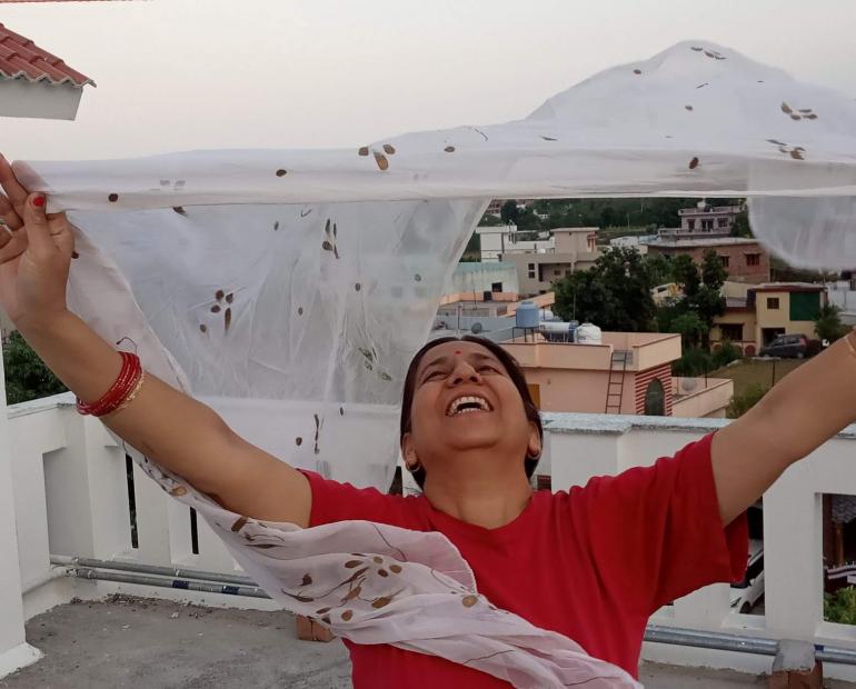 A picture of a woman flying her dupatta into the sky - symbolic of the fact that she wishes to rise above all shackles that society imposes on her