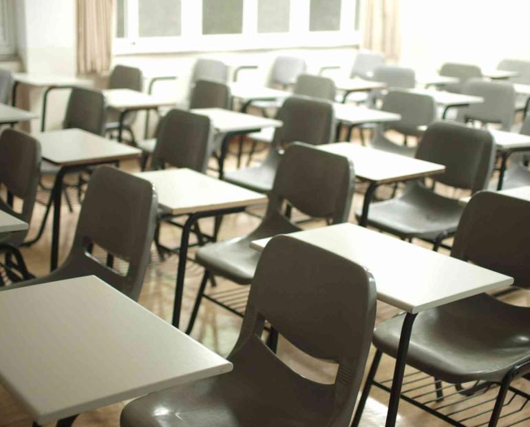A classrooms with chairs and desks.