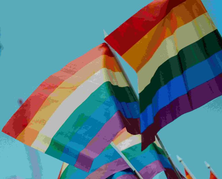 LGBTQI+ flags waving.