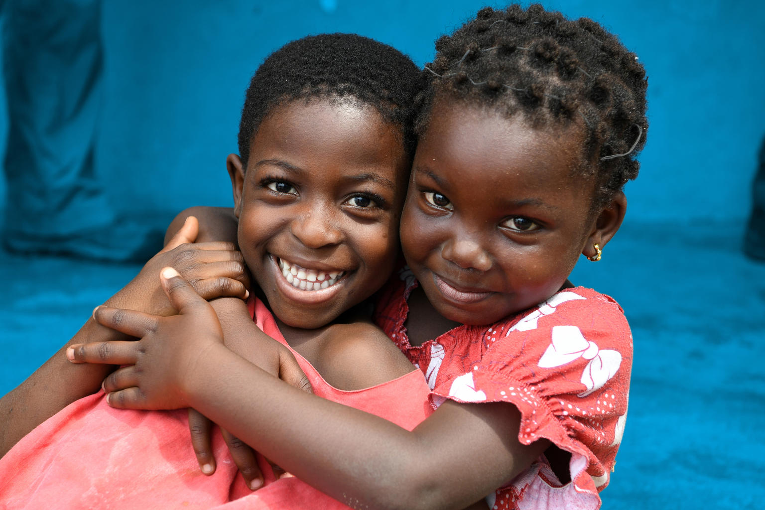Smiling girls hugging each other in Abidjan, the capital of Côte d'Ivoire.