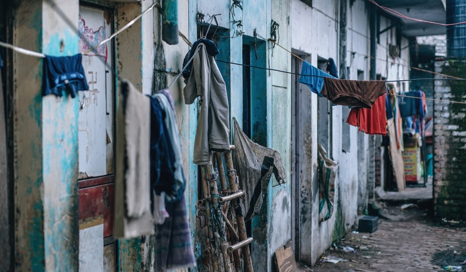 Clothes hang on a line outside a house.