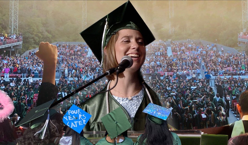 Lucy wearing a cap and gown for graduation at a podium laughing.