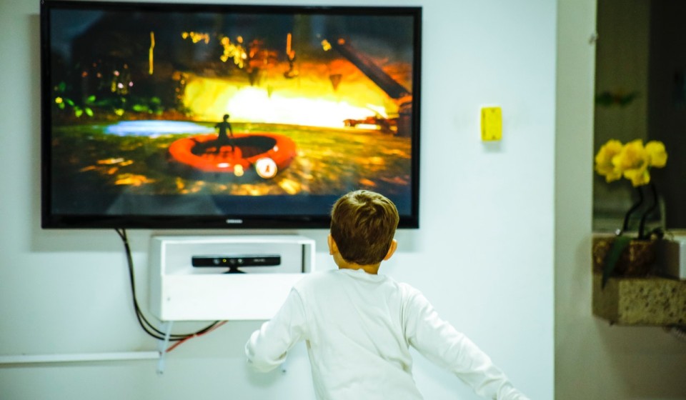A child looking at a TV screen