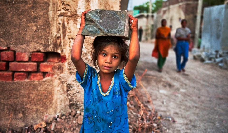 a child laborer working at a construction site in India 