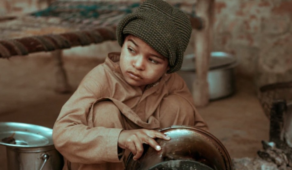 A child washing utensils