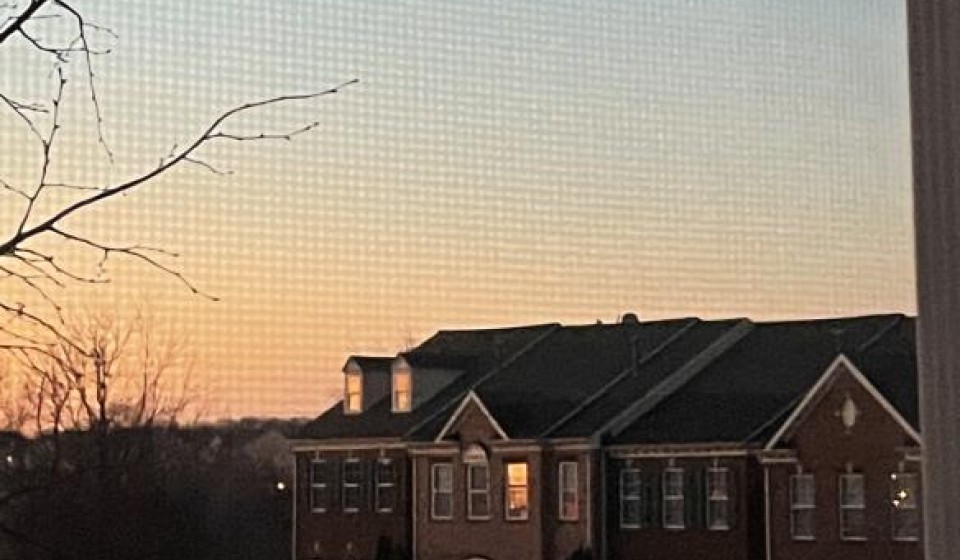 sunset reflecting in the windows of nearby houses.