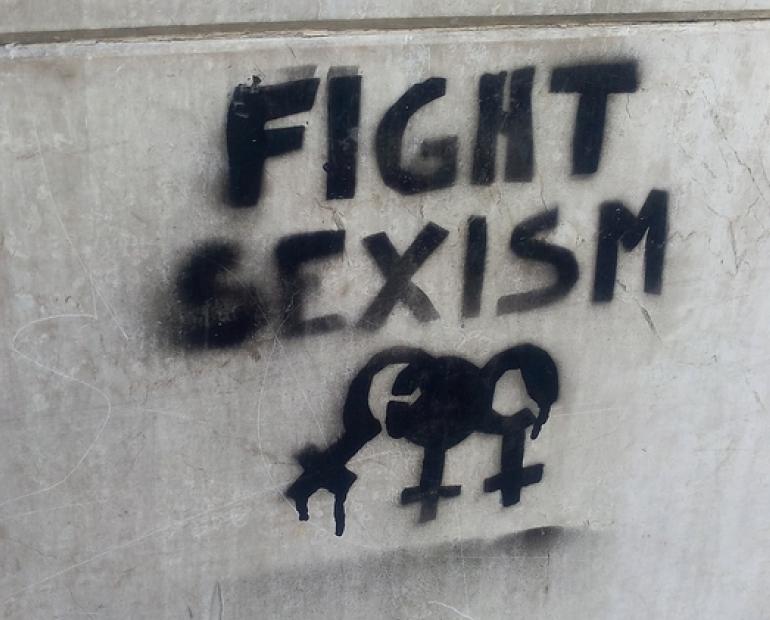A sign on a wall saying "Fight Sexism"