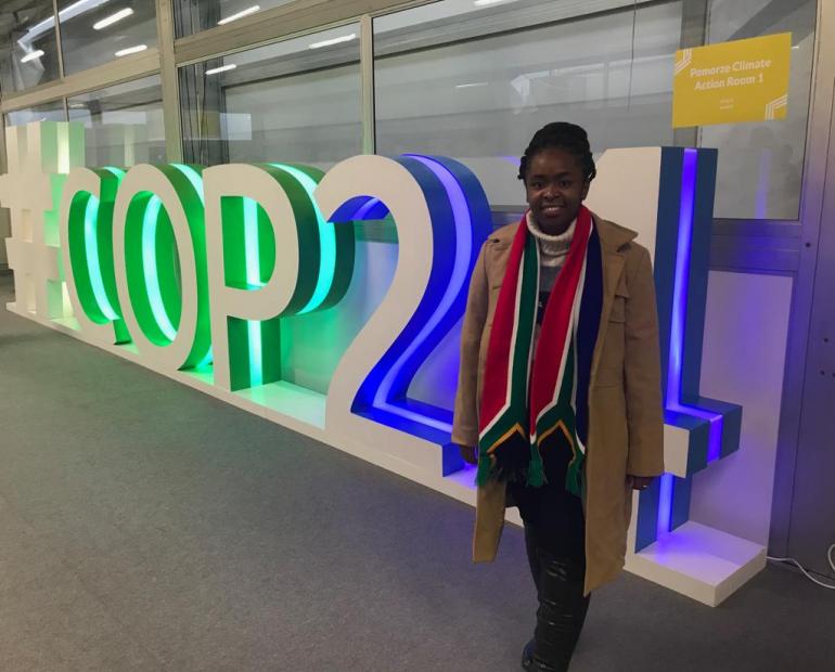 South African COP Youth Delegate, Ditebogo Lebea, poses in front of the COP sign