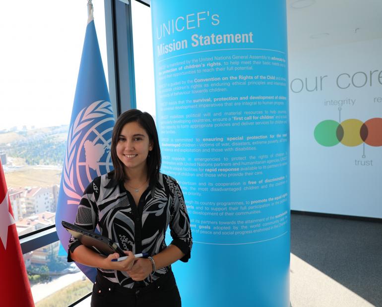 Yael in front of UNICEF flag