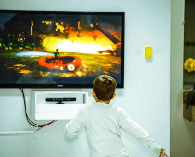A child looking at a TV screen