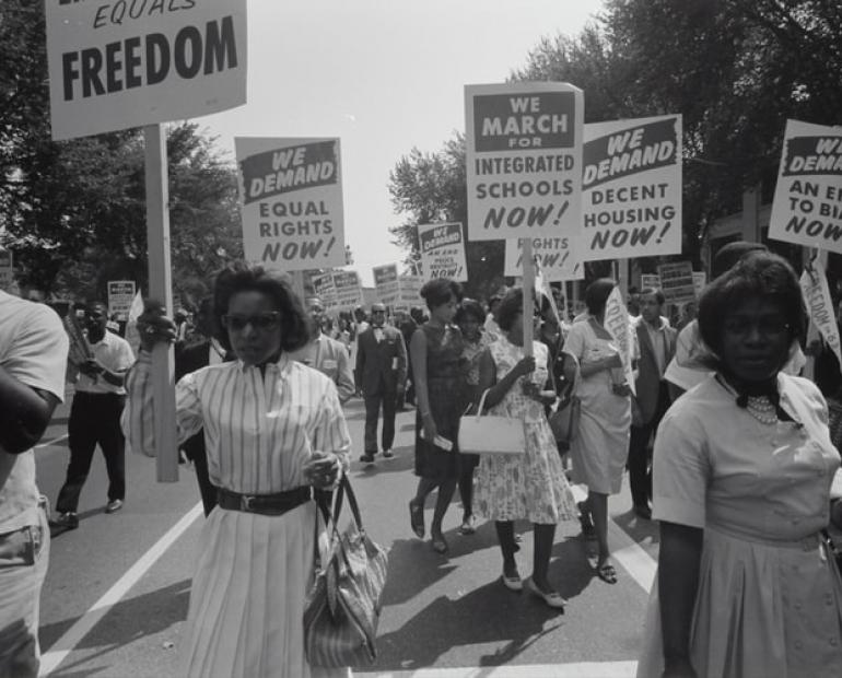 Civil rights march on Washington, D.C. Film negative by photographer Warren K. Leffler, 1963. From the U.S. News & World Report Collection. Library of Congress Prints & Photographs Division. Photograph shows a procession of African Americans carrying signs for equal rights, integrated schools, decent housing, and an end to bias. https://www.loc.gov/item/2003654393/