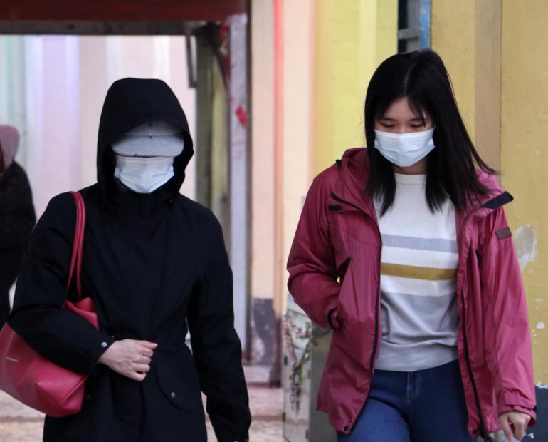 Two girls wearing masks