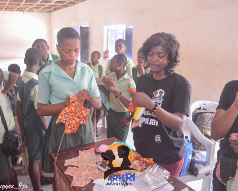 Teaching girls of Government Secondary school Odukpani how to make reusable pads