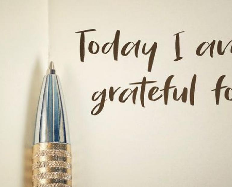 Book with pen and writing "Today I am grateful"