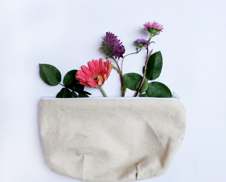A pouch with flowers coming out of it