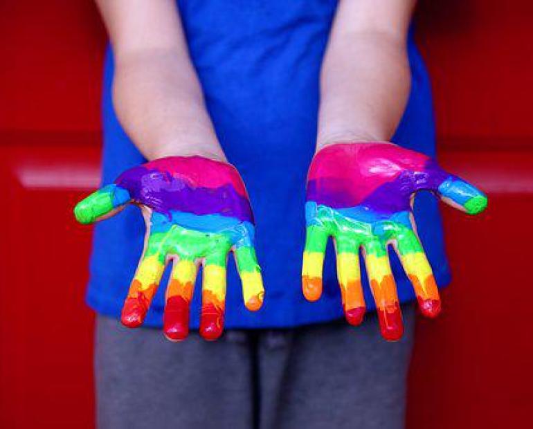 Hands painted the colours of the rainbow 