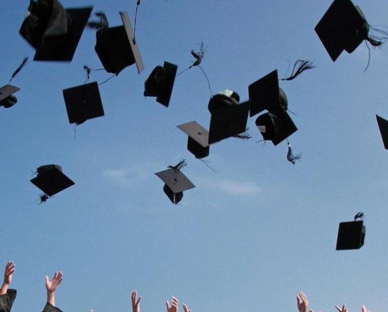 Graduation caps thrown up the air
