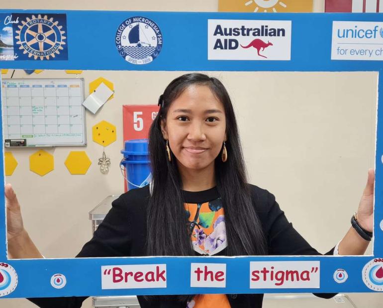 Girl holding photo frame with the caption "Break the stigma"