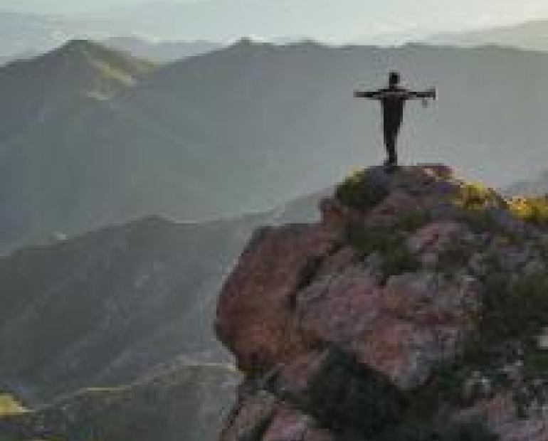 Person standing free on top of a cliff