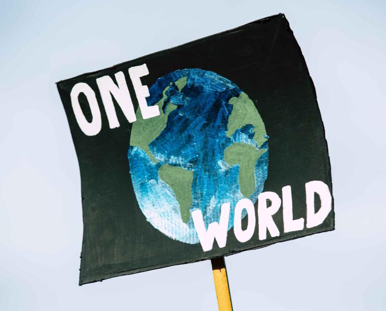 A sign says One world