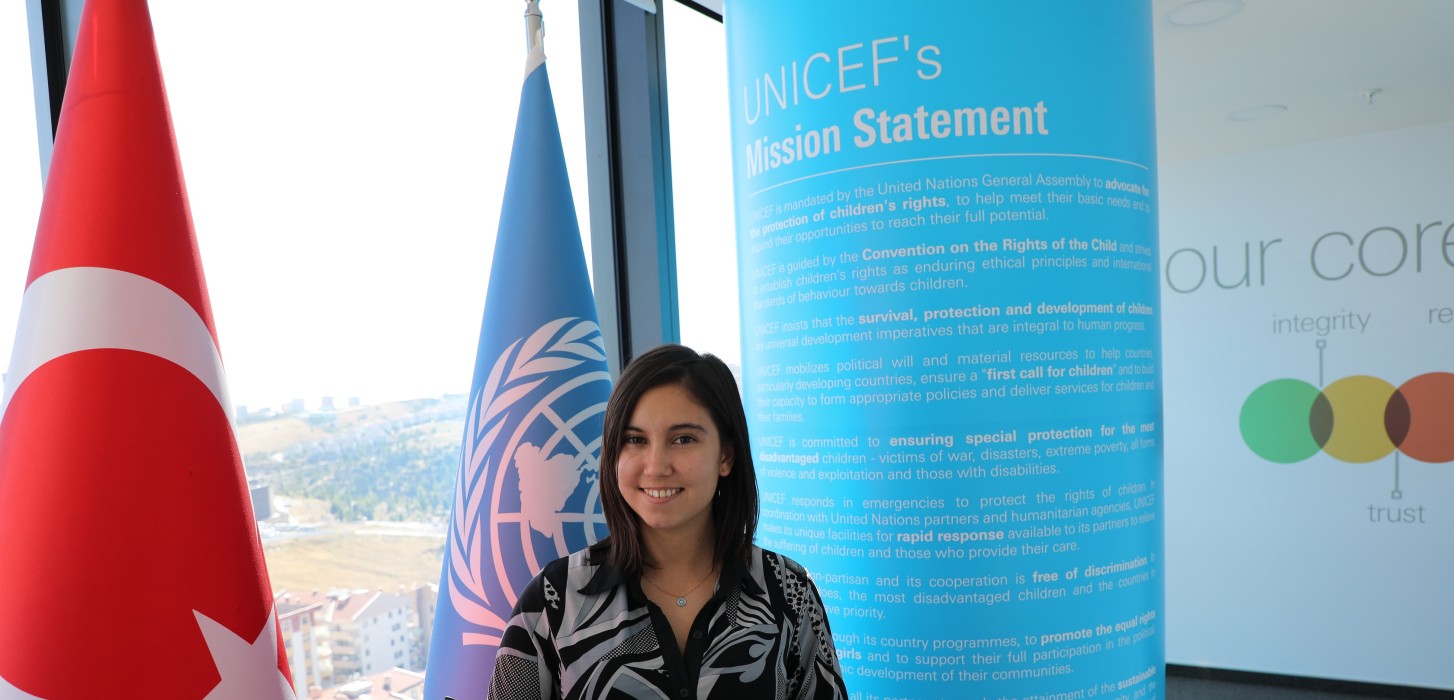 Yael in front of UNICEF flag