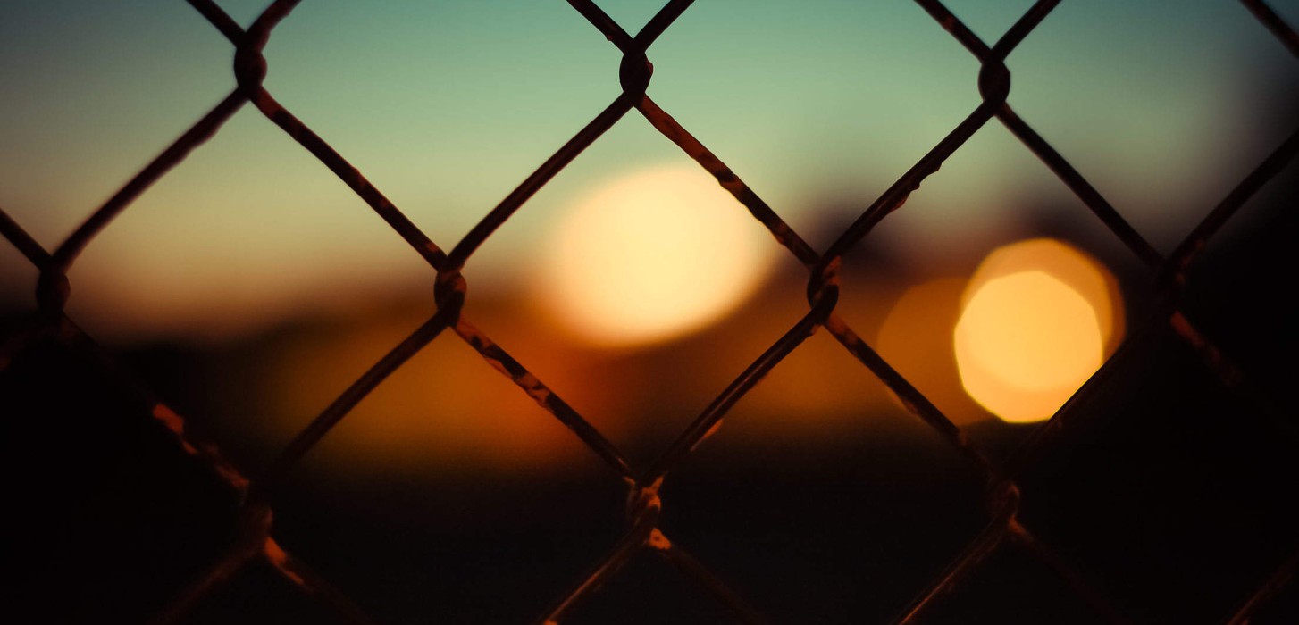Blurred out hues behind a fence
