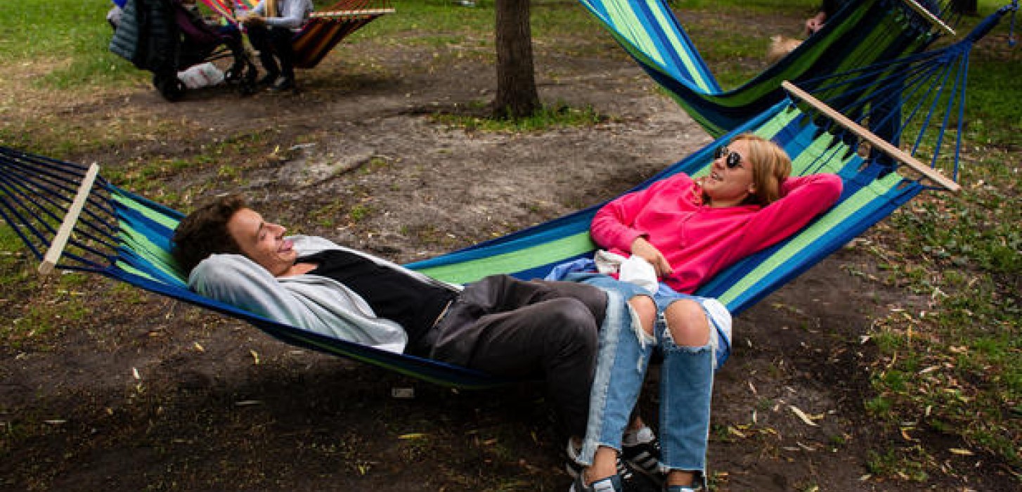 Dany Stolbunov, 20, and his friend, Anya, 19, relax on a hammock in Shevchenko Park 