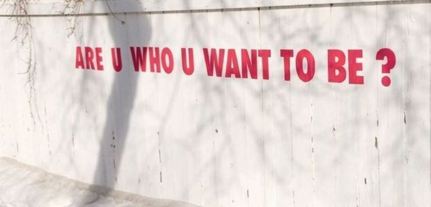 a wall that has the words "are you who you want to be"