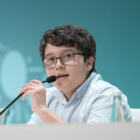 Francisco speaking to a microphone at COP28.