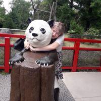 Me hugging a model of a panda at Berlin zoo