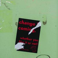 "change is coming, whether you like it or not" red text on black on pale