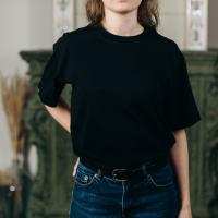 Person wearing black T-shirt and denim jeans