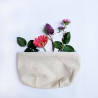 A pouch with flowers coming out of it