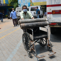 A health worker carries Oxygen cylinder on a wheel chair at MMC Covid hospital in Guwahati on April 30, 2021. 