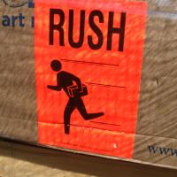 Sign of a stick person running with text above that reads 'RUSH'